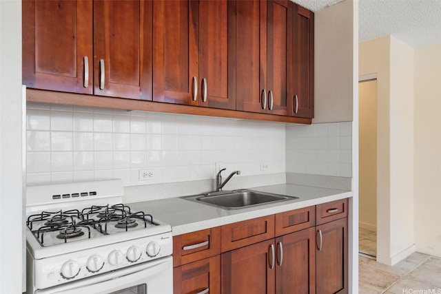 1550 Wilder Ave Unit A804, Honolulu, HI 96822 - kitchen featuring gas range gas stove, a sink, light countertops, light tile patterned floors, and a textured ceiling