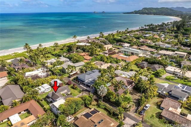 drone / aerial view featuring a residential view, a water view, and a beach view