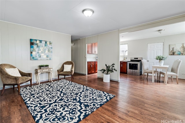 living area featuring dark wood-style flooring and baseboards