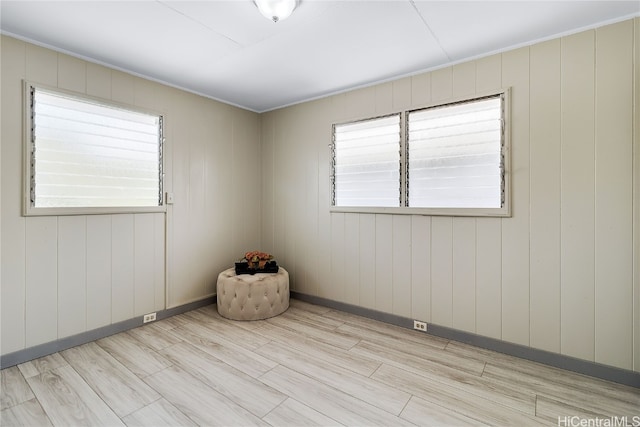 empty room featuring baseboards and light wood-style floors