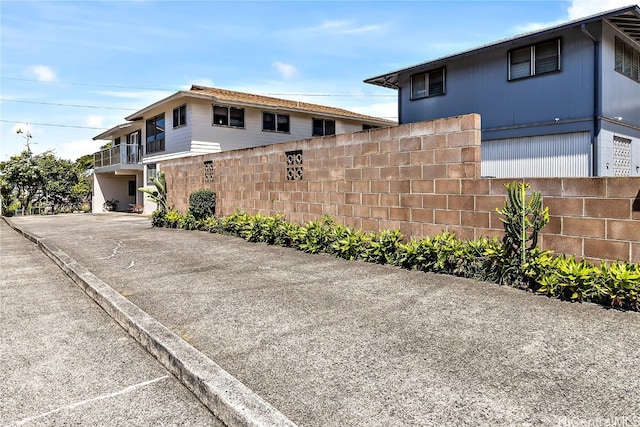 view of side of property featuring fence