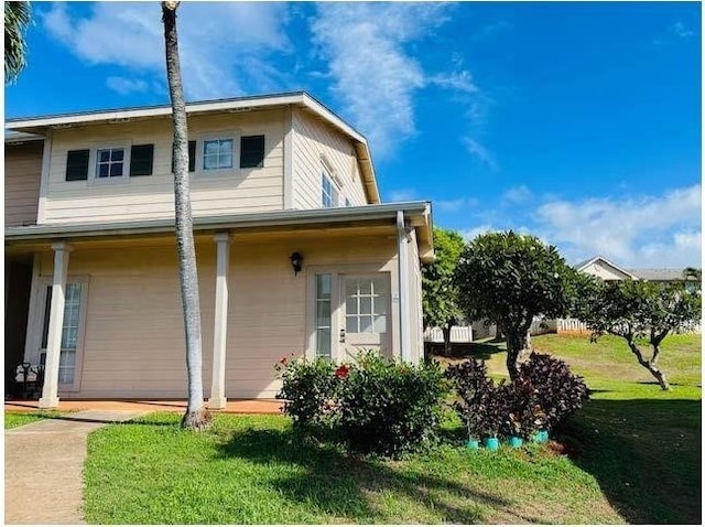 view of side of property with a lawn