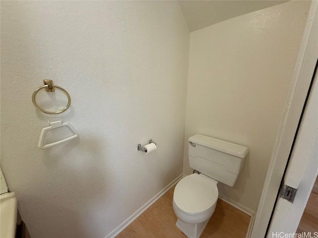 bathroom featuring baseboards, toilet, and wood finished floors