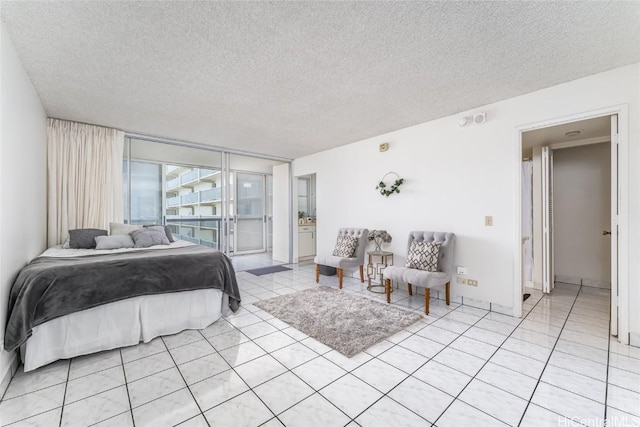 bedroom featuring a textured ceiling and light tile patterned floors