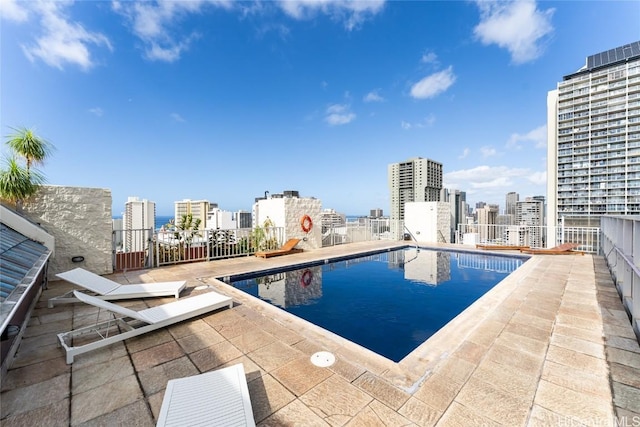 pool featuring a view of city and a patio