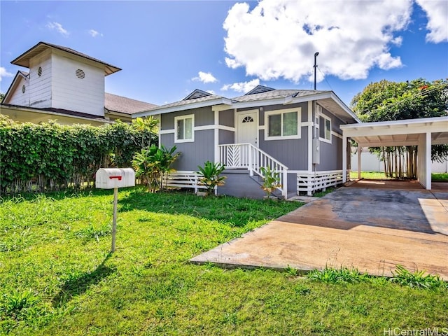 bungalow featuring driveway and a front lawn