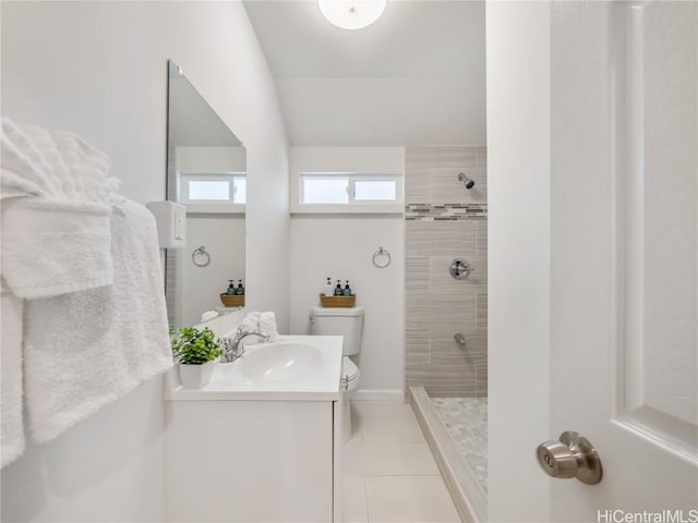 full bathroom with tile patterned flooring, a tile shower, vanity, and toilet