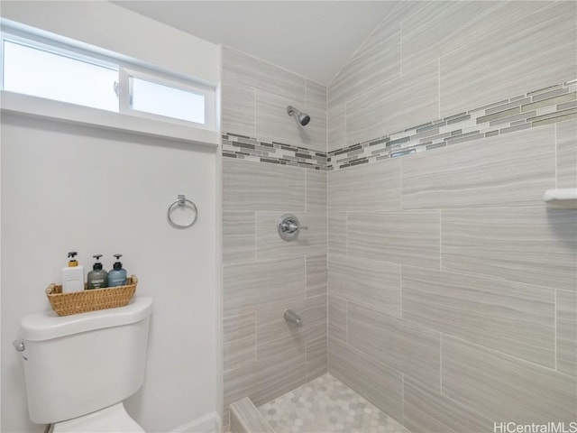 full bath featuring lofted ceiling and a tile shower