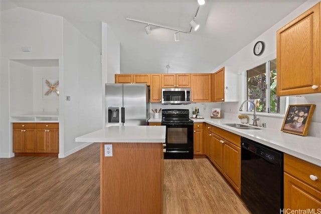 kitchen featuring a kitchen island, light countertops, a sink, and black appliances