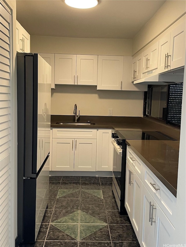 3138 Waialae Ave Unit 418, Honolulu, HI 96816 - kitchen featuring black electric range oven, a sink, dark countertops, freestanding refrigerator, and under cabinet range hood