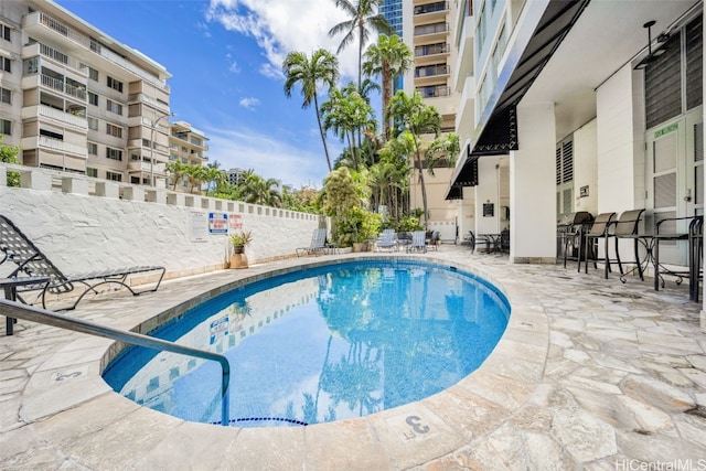 community pool featuring a patio area and fence