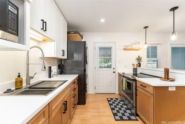 kitchen with stainless steel appliances, a sink, and light countertops