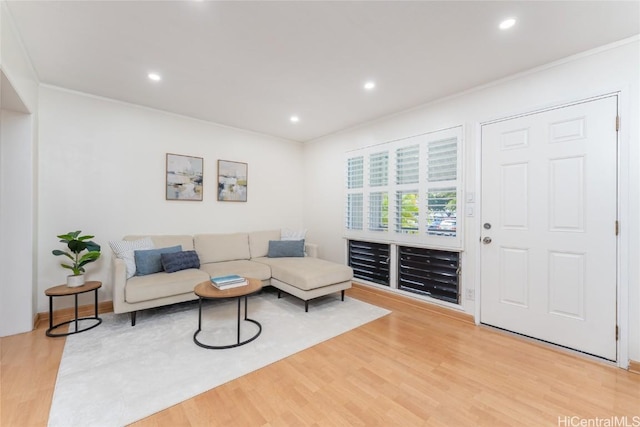 living room featuring recessed lighting, light wood-type flooring, and crown molding