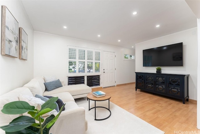 living area with wood finished floors and recessed lighting