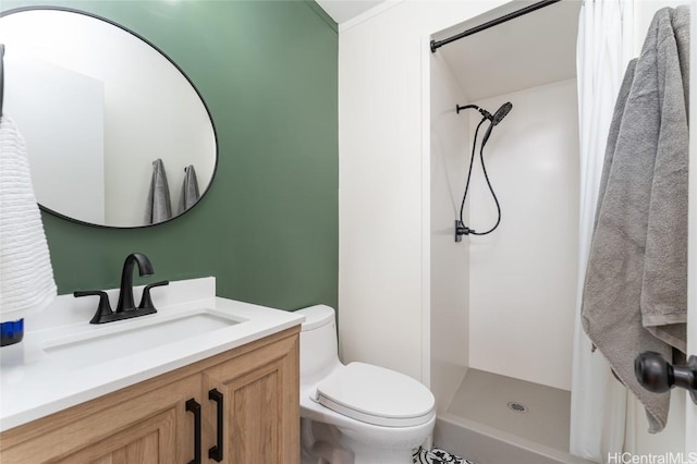 full bathroom featuring toilet, a shower stall, and vanity