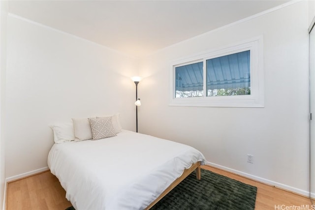 bedroom with baseboards and light wood-style floors