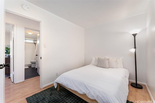 bedroom featuring light wood-type flooring and baseboards