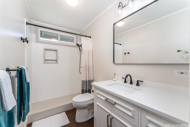 bathroom with a shower with shower curtain, toilet, ornamental molding, and vanity