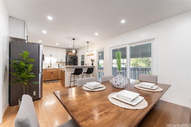 dining area with light wood-style flooring and recessed lighting