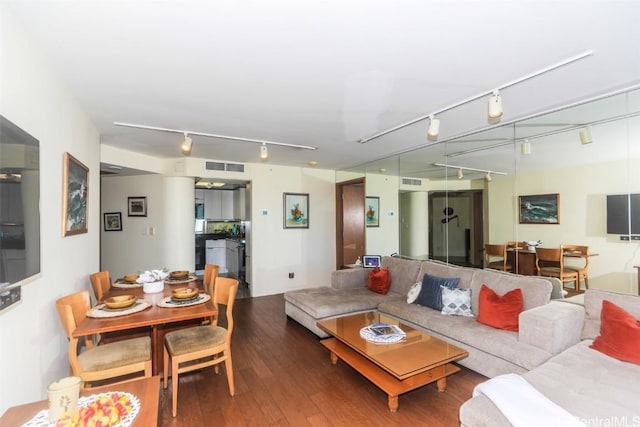 living room featuring wood finished floors, visible vents, and track lighting