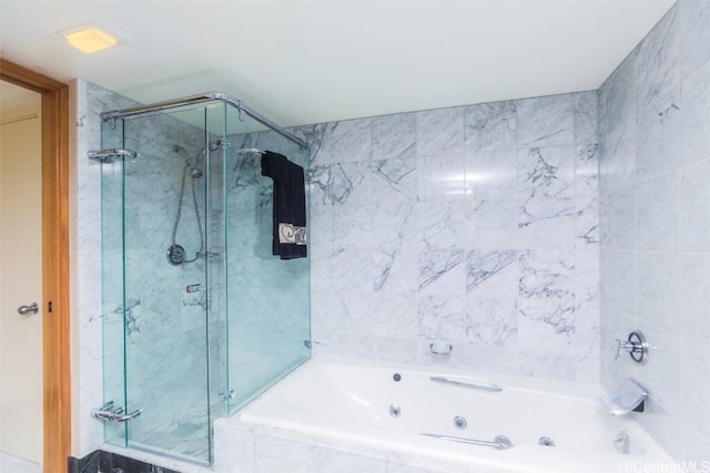 bathroom featuring a whirlpool tub and a stall shower