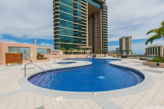 pool featuring a view of city and a patio