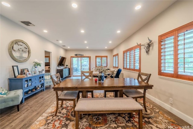 dining area with a healthy amount of sunlight, visible vents, wood finished floors, and recessed lighting