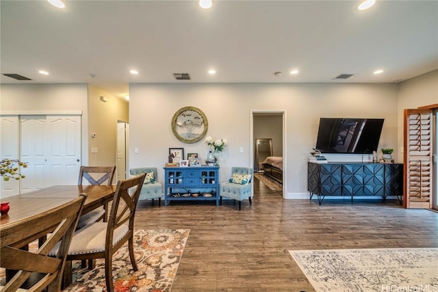 dining room featuring wood finished floors, visible vents, and recessed lighting