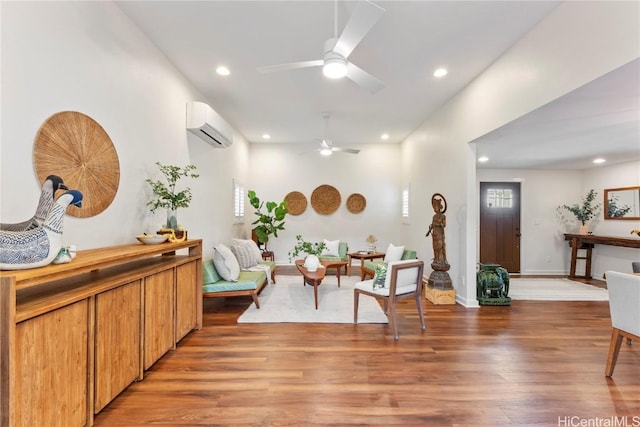 living area with light wood-style floors, baseboards, an AC wall unit, and recessed lighting