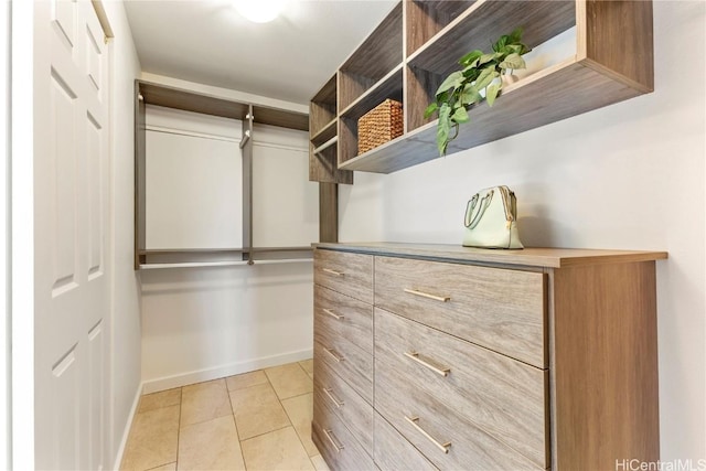 spacious closet with light tile patterned flooring