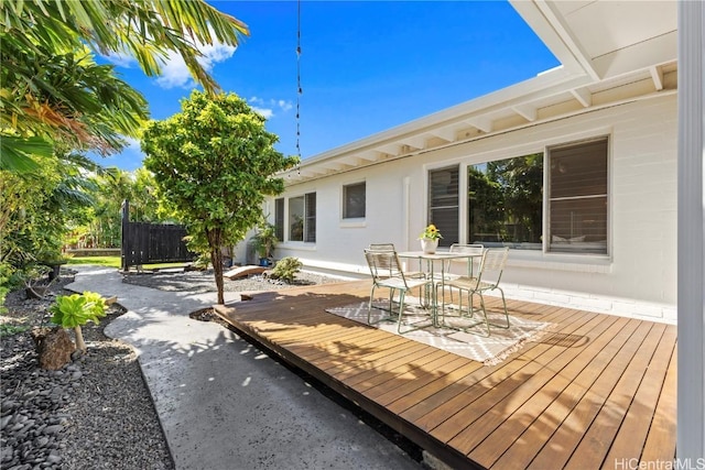 wooden terrace featuring outdoor dining area