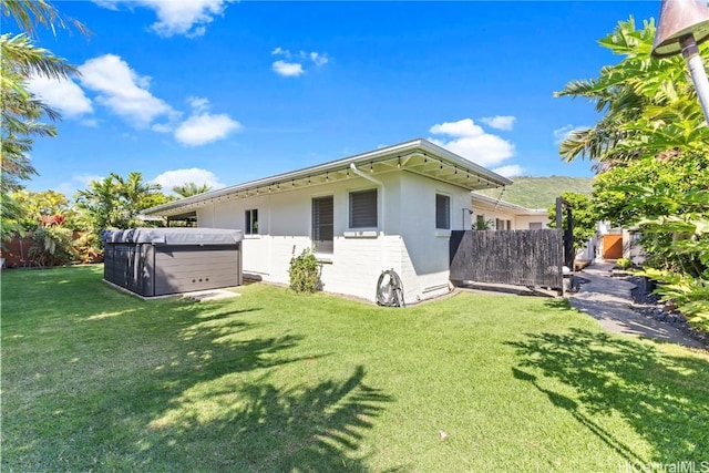 view of property exterior with fence and a yard