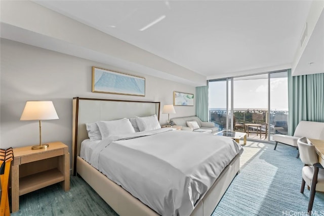 bedroom featuring access to exterior, dark colored carpet, and floor to ceiling windows