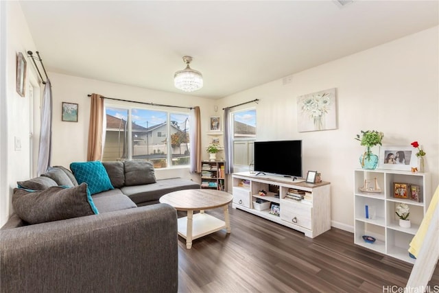 living room with baseboards and dark wood-type flooring