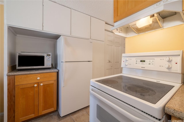 kitchen with under cabinet range hood, brown cabinetry, white appliances, light countertops, and white cabinets