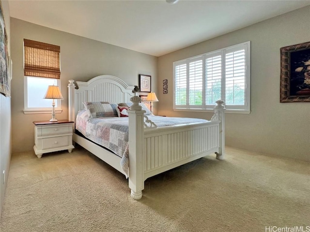 bedroom featuring light colored carpet