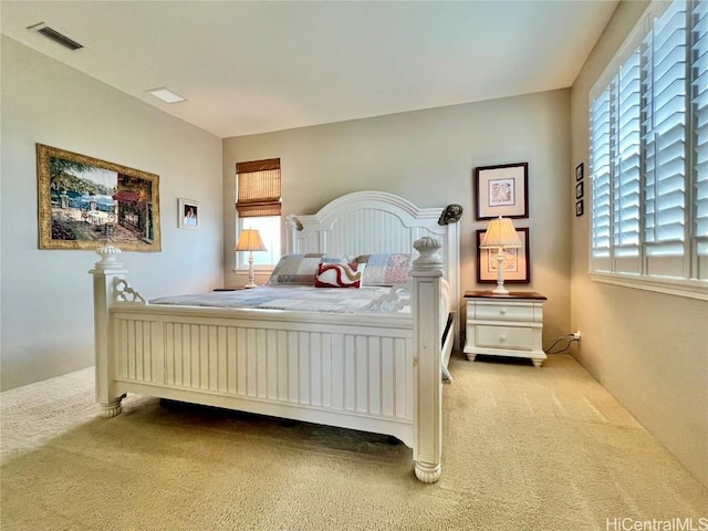 carpeted bedroom featuring visible vents