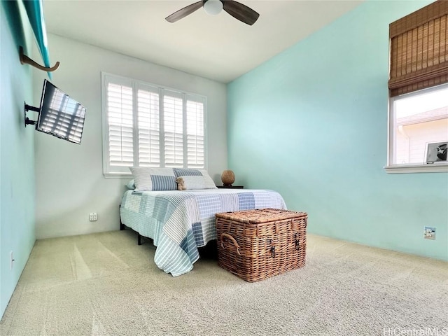 carpeted bedroom with ceiling fan and lofted ceiling