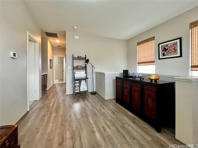 interior space featuring light wood-type flooring and visible vents