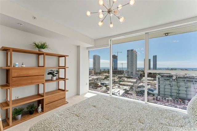 interior space with expansive windows, a view of city, a chandelier, and light colored carpet