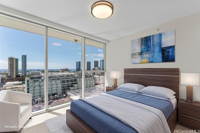 bedroom featuring floor to ceiling windows and a city view