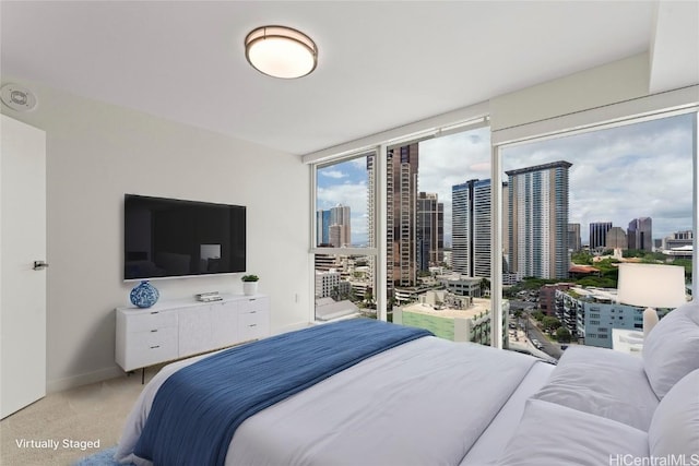 bedroom featuring expansive windows, light carpet, and baseboards