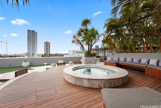 wooden deck with a city view and hot tub deck surround