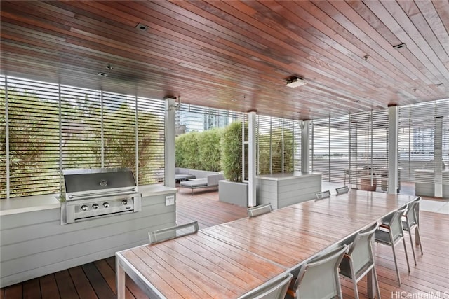 wooden deck featuring an outdoor kitchen, outdoor dining area, grilling area, and an outdoor living space