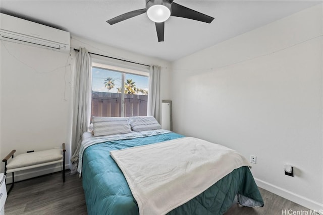 bedroom featuring a wall unit AC, lofted ceiling, a ceiling fan, wood finished floors, and baseboards