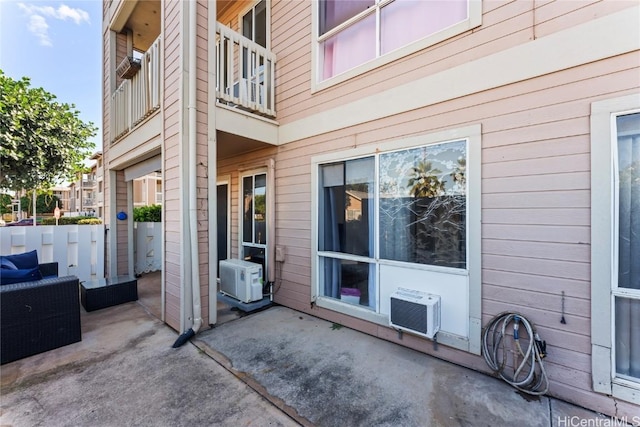 view of patio with cooling unit and a balcony