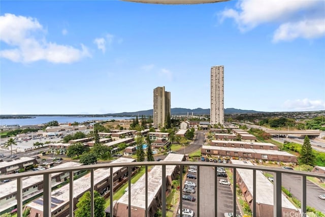 balcony with a water view and a city view