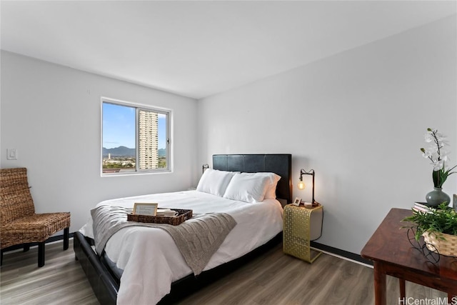 bedroom with baseboards and wood finished floors