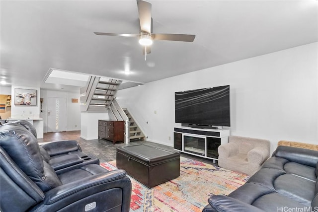 living room with stairs and ceiling fan