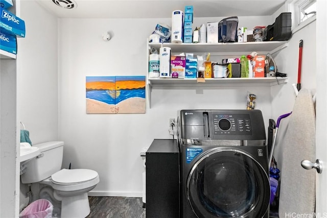 laundry area featuring laundry area, wood finished floors, visible vents, baseboards, and washer / dryer